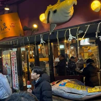 Paper lanterns and signboards hung over a shopfront in the Tsukiji Outer Market